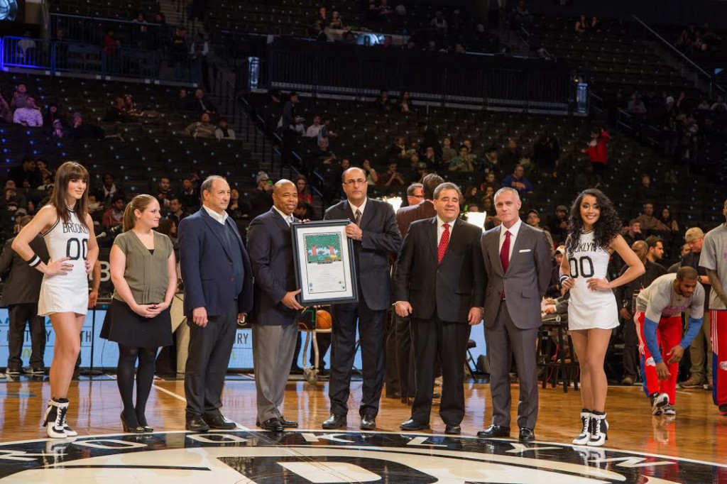 Photo Credit to Tal Atzmon: Brooklyn Borough President Eric L. Adams is presented with the State of Israel's annual Martin Luther King Jr. Award by Consul General of Israel in New York Ambassador Ido Aharoni, JNF's Russell Robinson and JCRC-NY's Hindy Poupko, during a pregame ceremony before the Brooklyn Nets hosted the Los Angeles Clippers at the Barclays Center, Monday. From left: Hindy Poupko, Barclays Center Majority Owner Bruce Ratner, Eric L. Adams, Ido Aharoni, Russell Robinson and CEO of the Brooklyn Nets and Barclays Center Brett Yormark. 