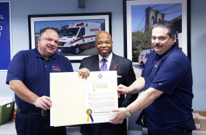 Brooklyn Borouh President Eric L. Adams presents Anthony Rapisarda (left) and Paul Rapisarda (right) of Midwood Ambulance Service with a citation that recognizes them as the first honoree of Brooklyn’s Community Businesses, a series he launched to honor local businesses with a commitment to their communities.