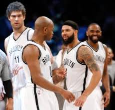 The Nets celebrate after Jarrett Jacks game-winning jumper.