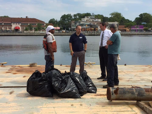 City Councilman Chaim Deutsch alongside DEP Spokesperson Doug Auer surveying the dozen bags of debris collected during the morning’s clean up effort