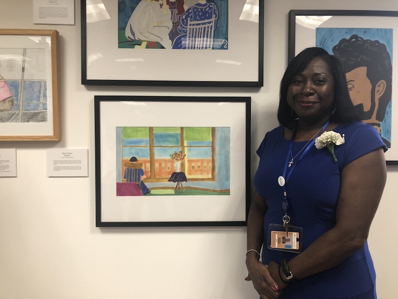 Muriel Fenner with with one of her many art pieces as part of the _Moments In Time_ Exhibition at Maimonides Medical Center