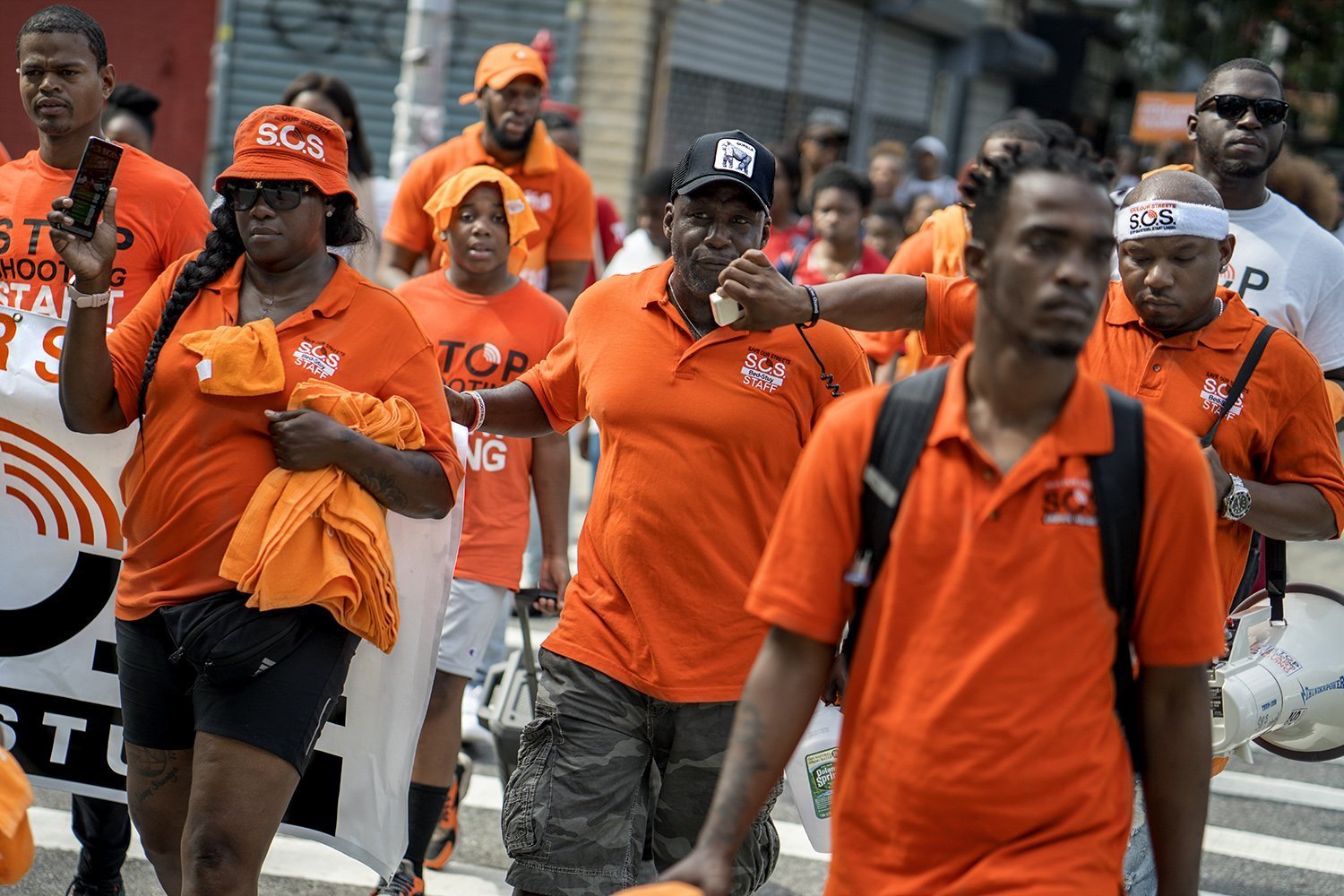 S.O.S. organizer Joseph Simmon (center) leading the march across the streets of Bed-Stuy. (Photo by Tsubasa Berg)