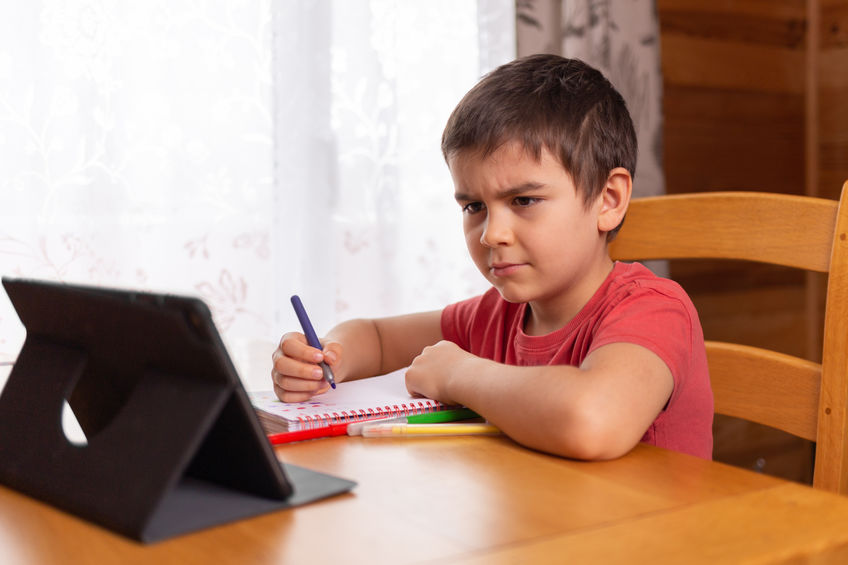 preschool boy learning at home. online remote school. doing homework