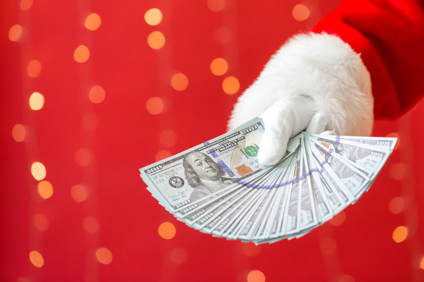 Santa holding US dollar bills