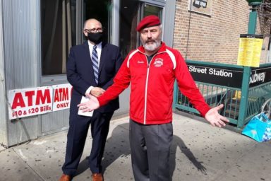 Mayoral Candidate Curtis Sliwa wearing red Guardian Angel jacket and red beret outside.