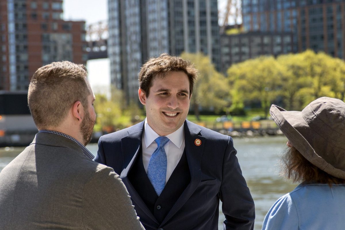 Council Member Ben Kallos chatting with two individuals by the waterfront.