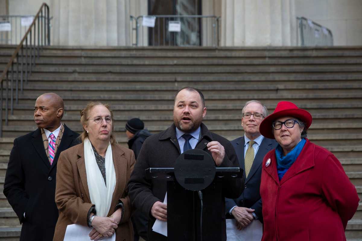 Speaker Corey Johnson speaking on the podium in front of City Hall