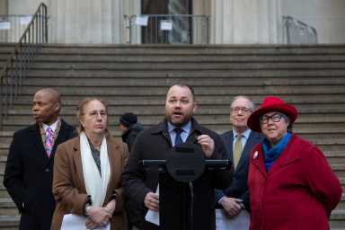 Speaker Corey Johnson speaking on the podium in front of City Hall