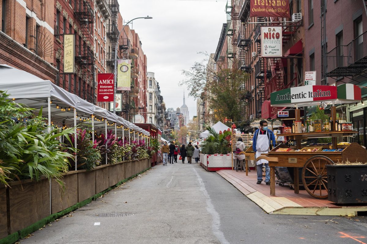 A street in LIttle Italy with Sidewalk Seating areas on each side (Photo by Tsubasa Berg)