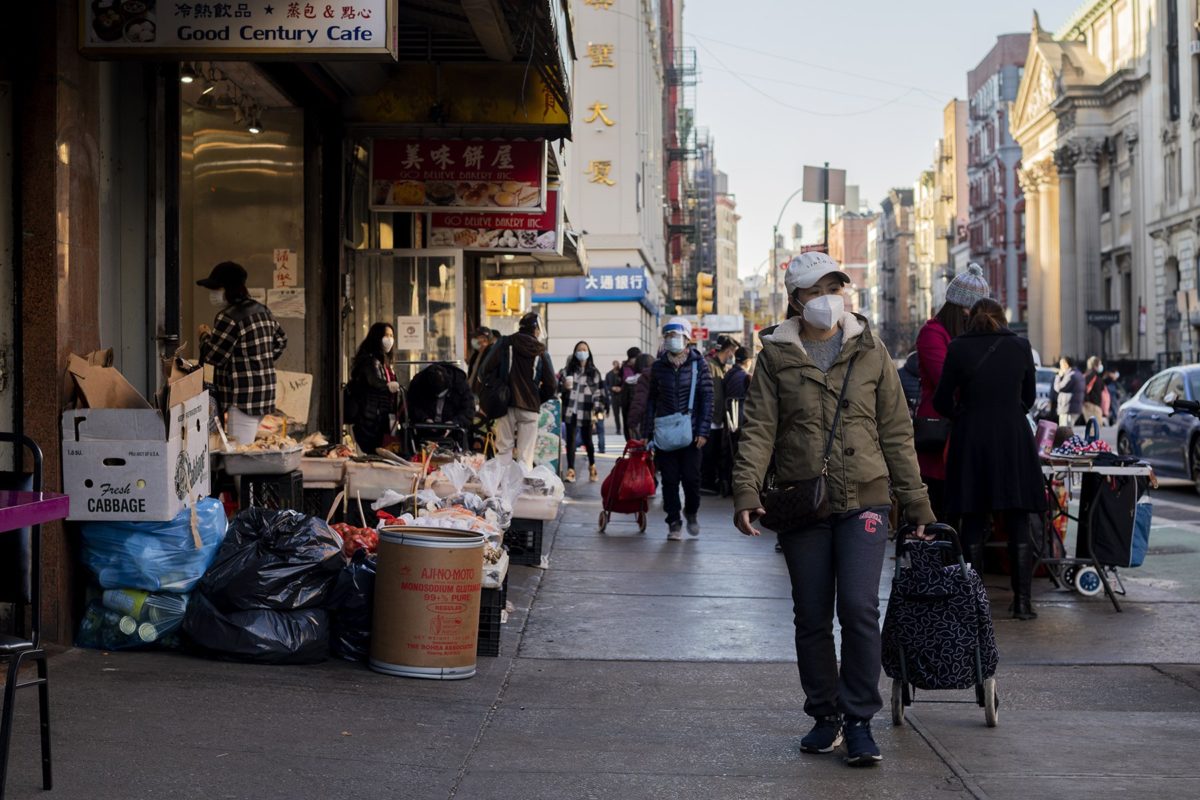 Chinese pedestrians walking in street of Manhattan Chinatown