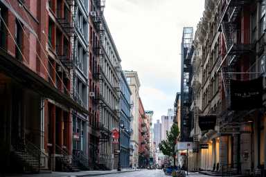 A street view of Prince street. Old Cast Iron buildings occupied by boutique design stores.