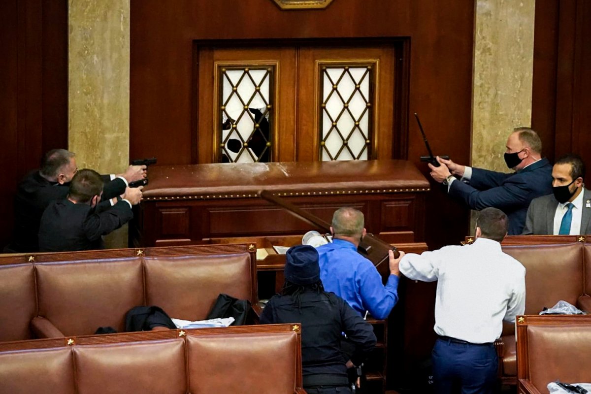 Law enforcement barricade the door to the Senate floor to keep Pro-Trump protesters out.