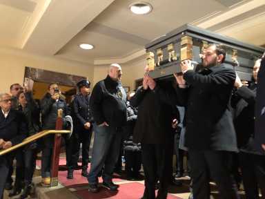 Casket of late State Senator Jose Peralta is carried out of the St. Joan of Arc church in Queens