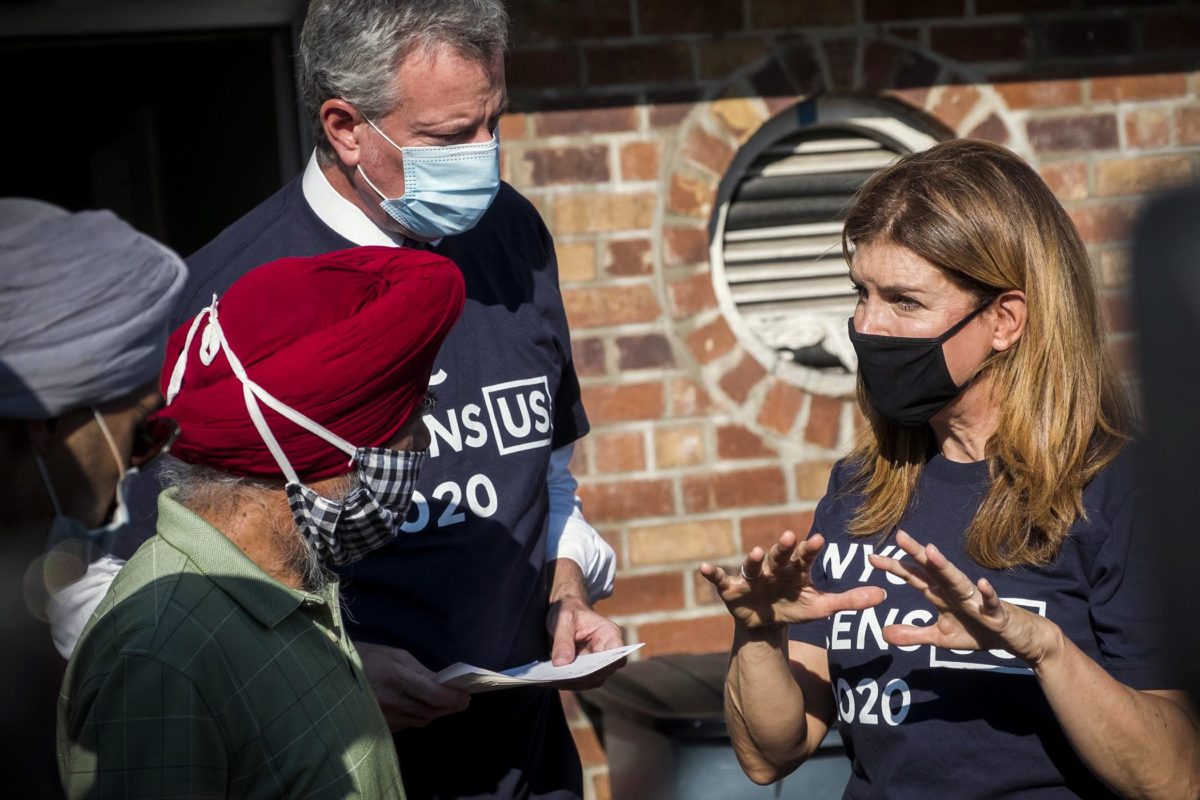Julie Menin and Mayor Bill de Blasio, both wearing mask, speaking to New Yorkers about census.