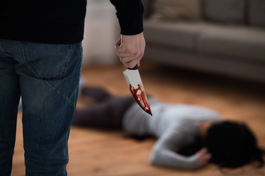 criminal with knife and dead body at crime scene