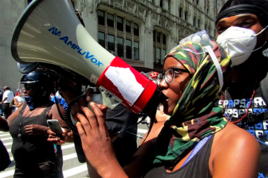 An Occupy City Hall protester on the bullhorn. Photo by Ariama C. Long