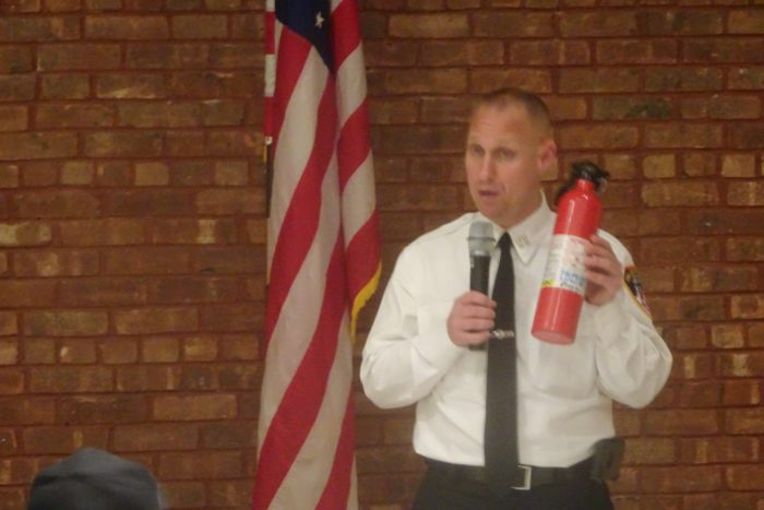 FDNY Chief Michael Kozo holds up an ABC class fire extinguisher for the audience to see (Photo by William Engel)