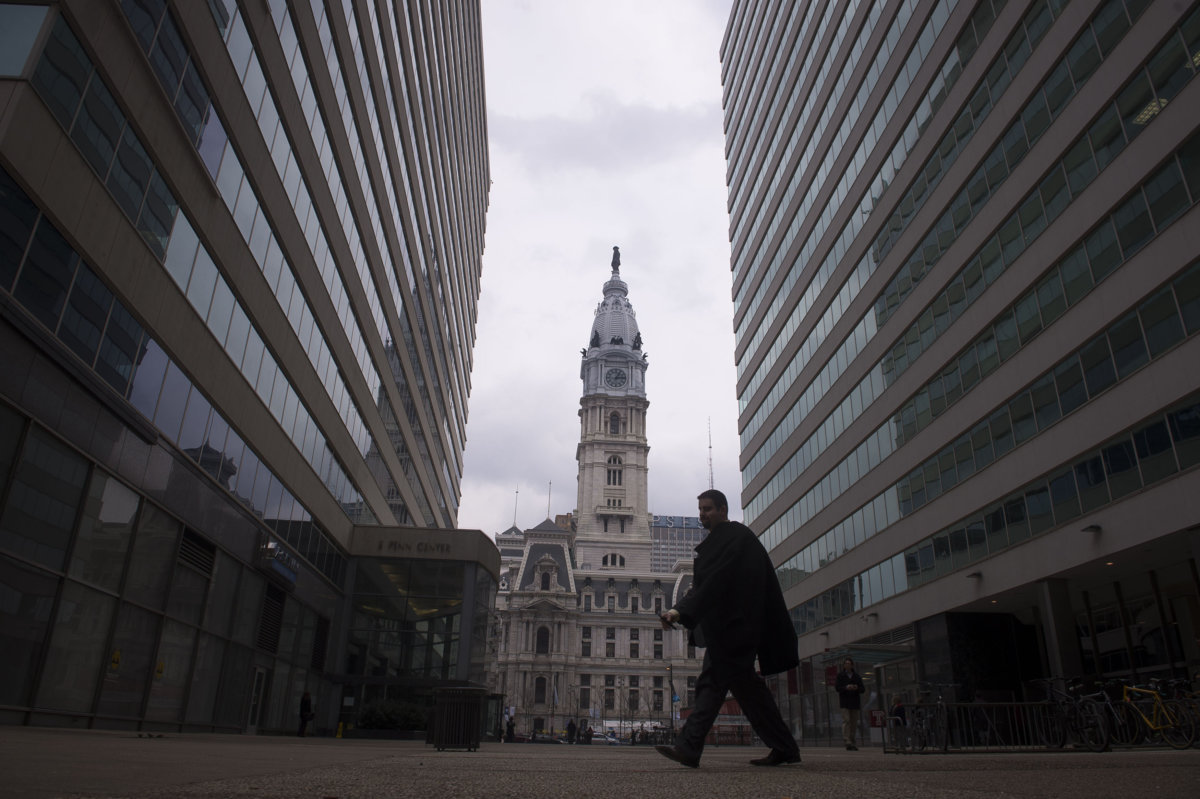 A man walks in front of City Hall in Philadelphia