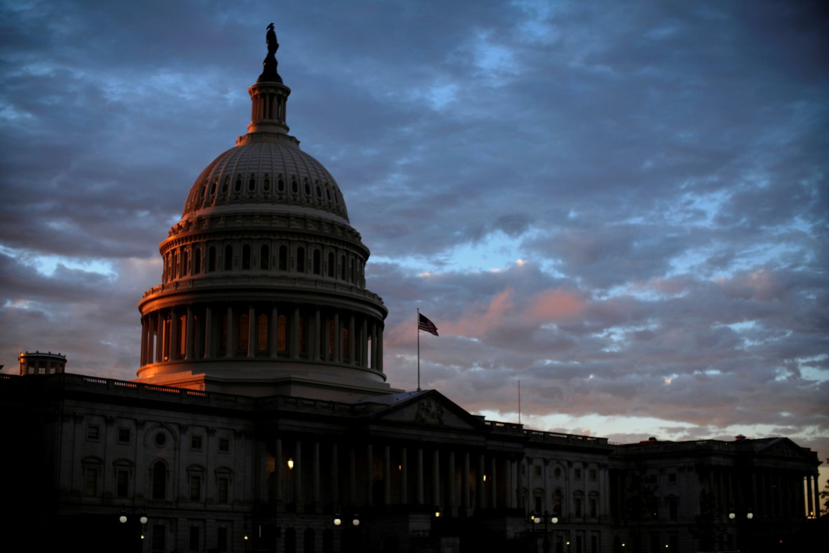 FILE PHOTO: The sun sets behind the U.S. Capitol dome in Washington