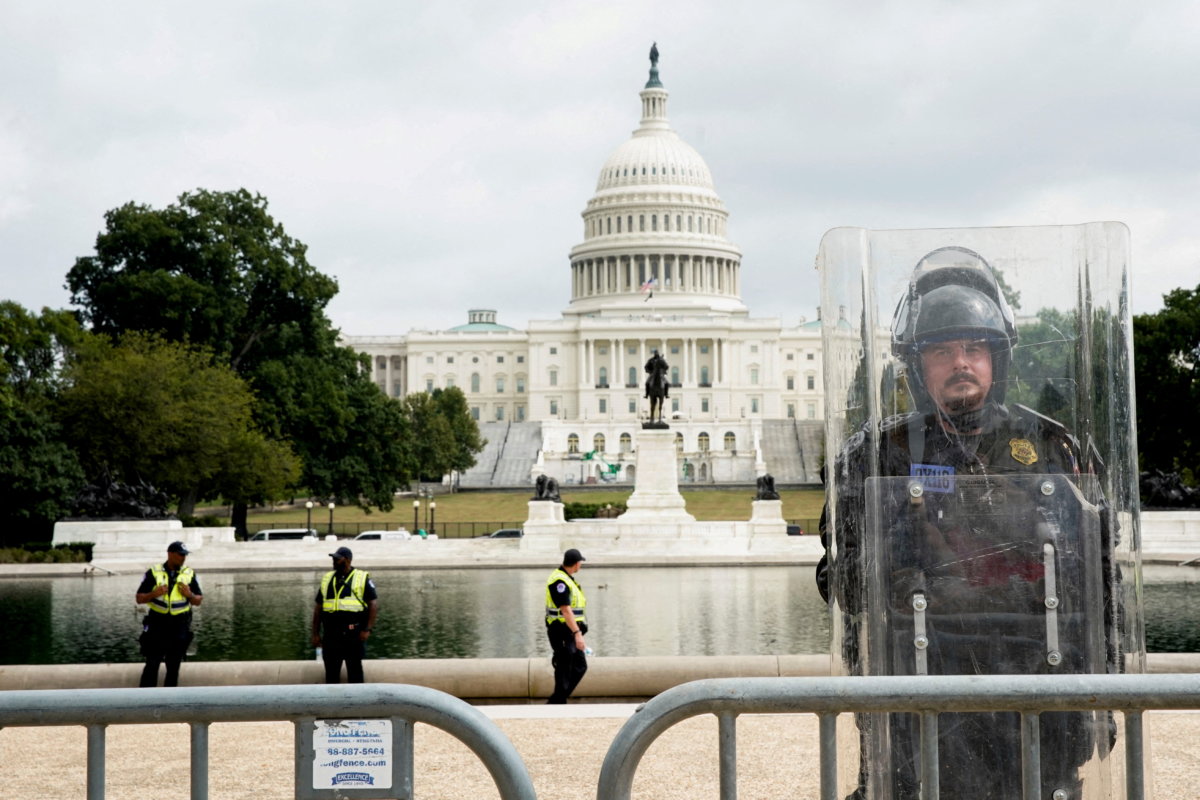 FILE PHOTO: A riot police officer stands guard during a rally in support of defendants being prosecuted in the January 6 attack on the Capitol