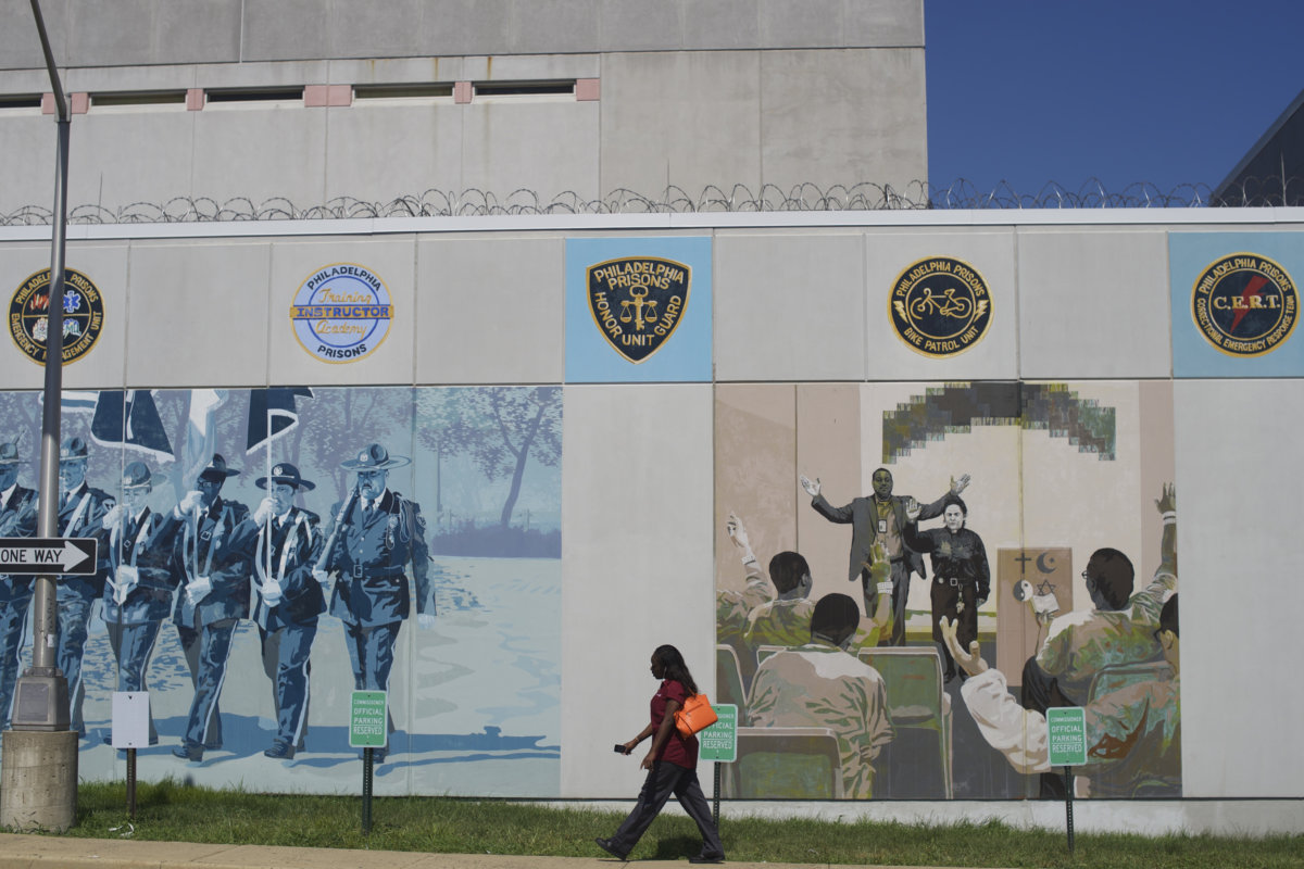 Murals painted by inmates and barbed wire are seen outside Curran-Fromhold Correctional Facility in Philadelphia, Pennsylvania
